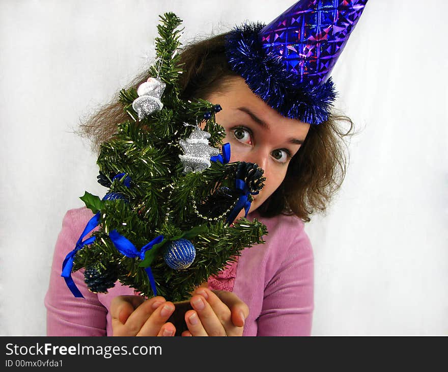 Woman looking over Christmas tree. Woman looking over Christmas tree