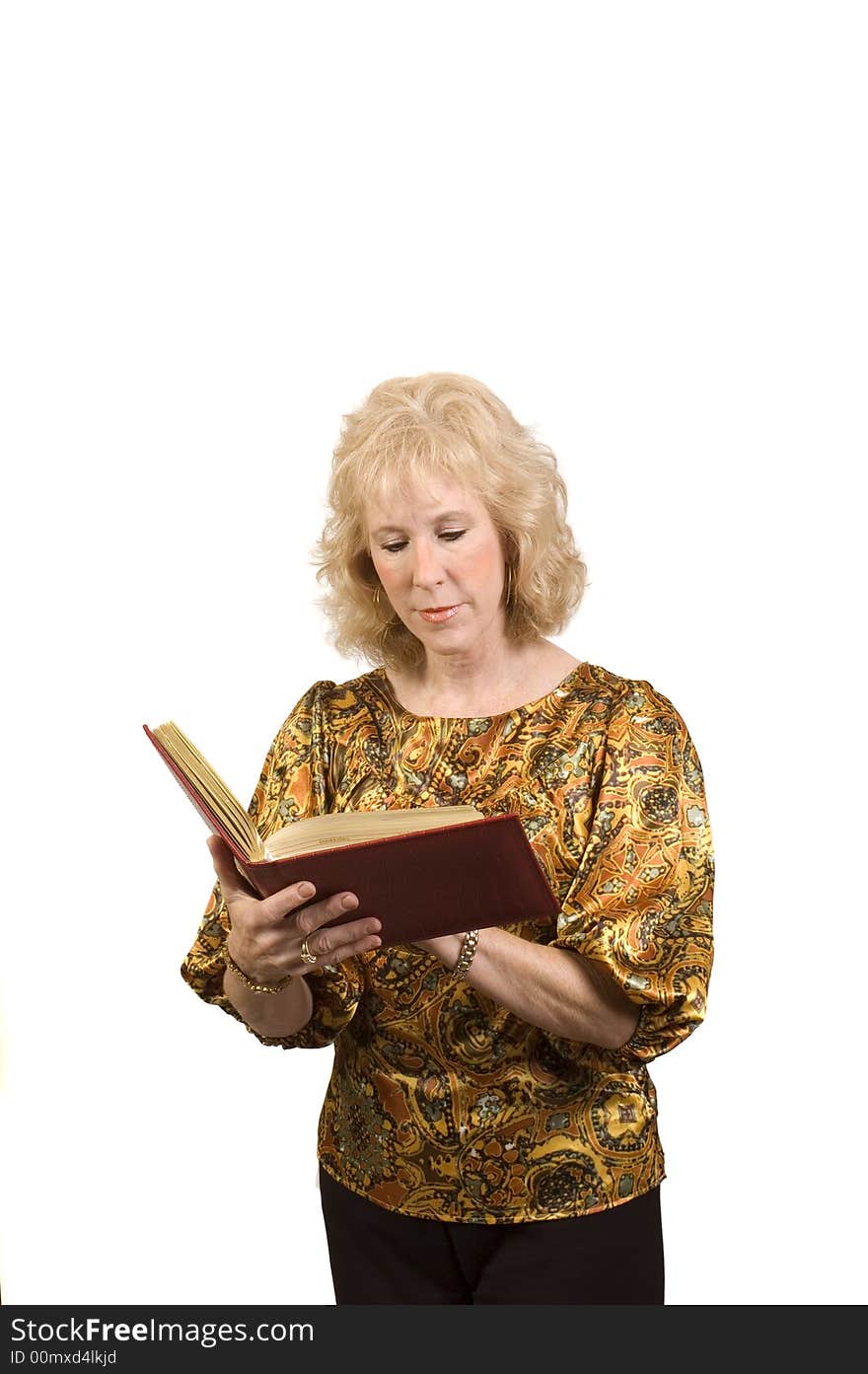 Attractive older woman holding a address book as she is checking addresses and isolated. Attractive older woman holding a address book as she is checking addresses and isolated