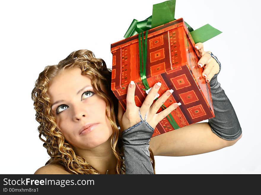 The girl with a gift in cheerfully box smiles new year