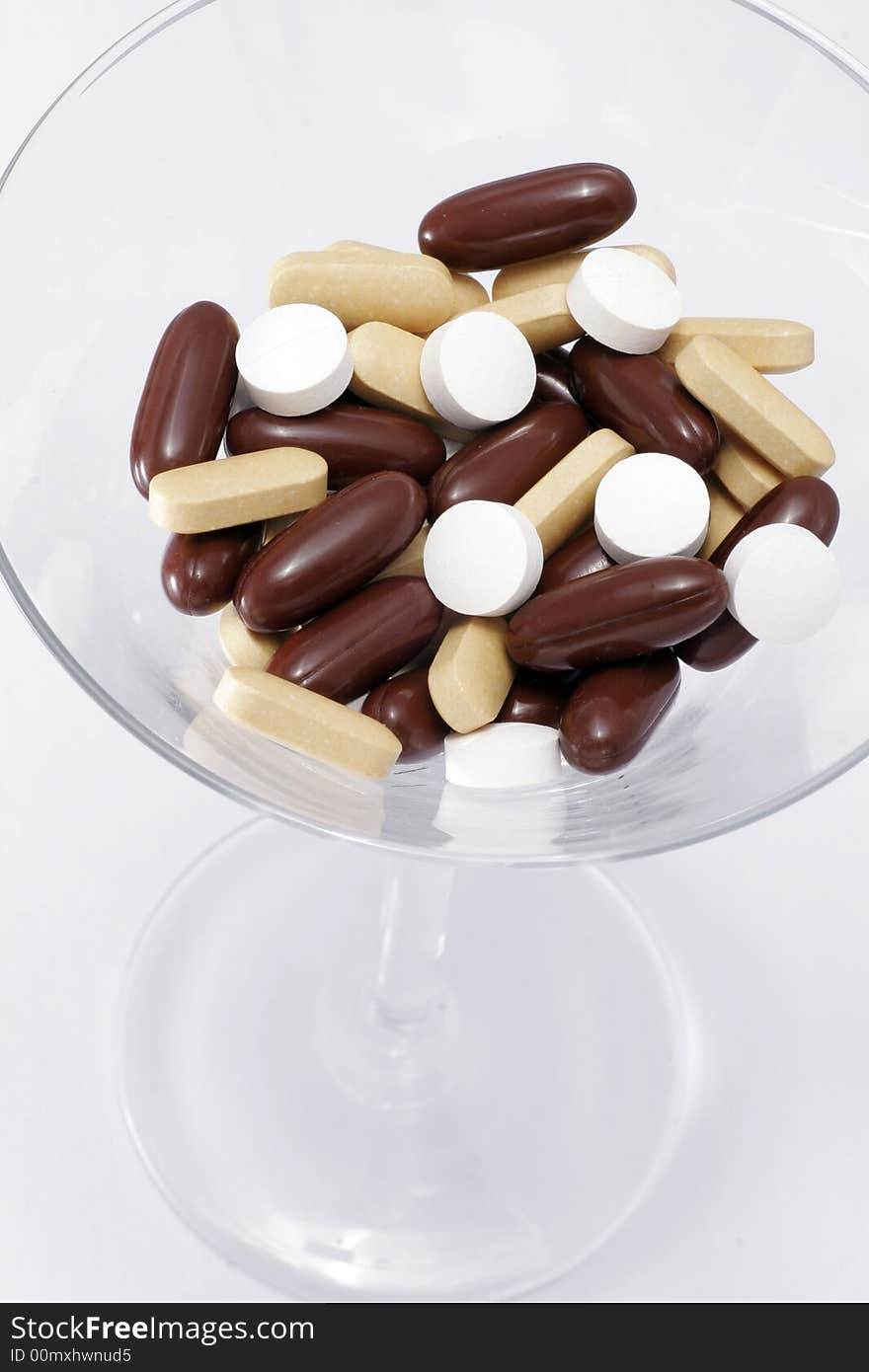 Deadly Cocktail - A Martini Glass Filled With A Mixture Of Pills- White Background