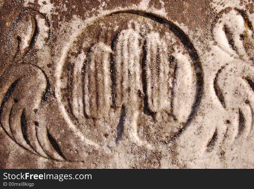 A close-up image of a headstone in a cemetery to show texture. A close-up image of a headstone in a cemetery to show texture