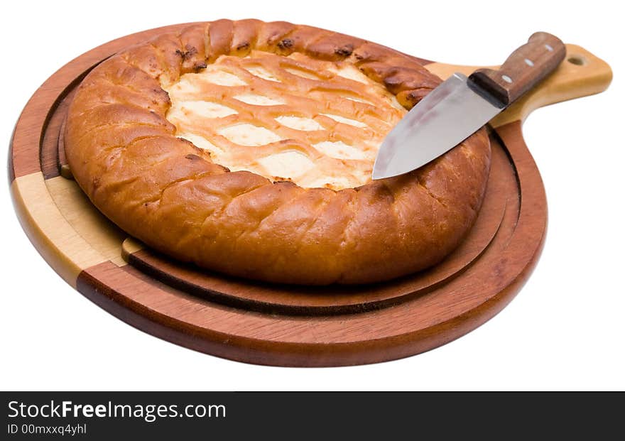 Celebratory pie on a chopping board with a knife.