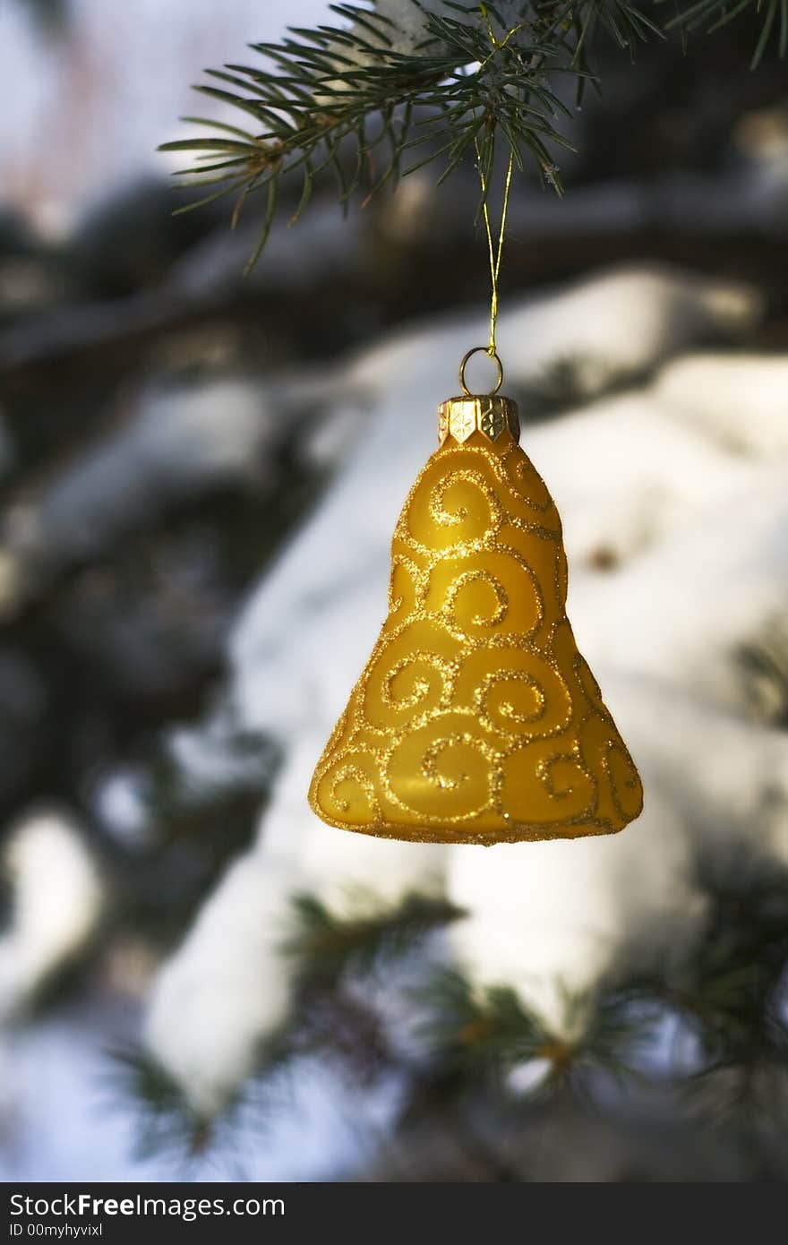 Christmas tree decoration handing on fir tree covered with snow. Christmas tree decoration handing on fir tree covered with snow