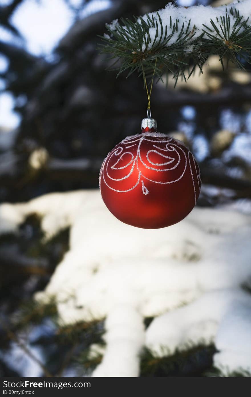 Christmas tree decoration handing on fir tree covered with snow. Christmas tree decoration handing on fir tree covered with snow