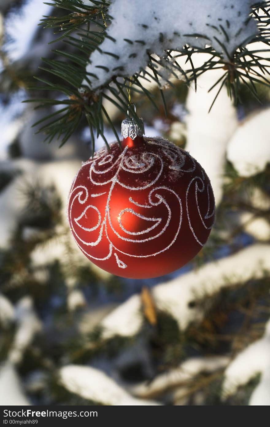 Christmas tree decoration handing on fir tree covered with snow. Christmas tree decoration handing on fir tree covered with snow