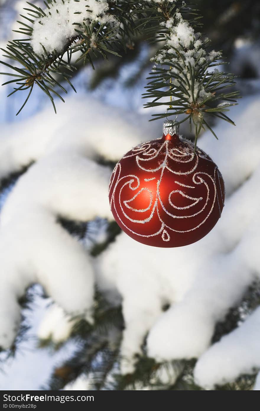 Christmas tree decoration handing on fir tree covered with snow. Christmas tree decoration handing on fir tree covered with snow