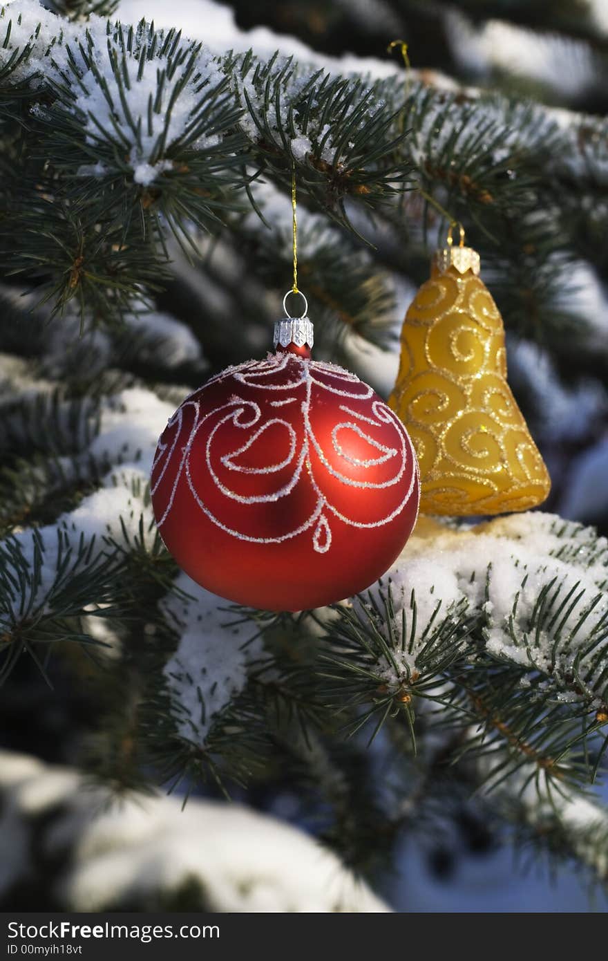 Christmas tree decoration handing on fir tree covered with snow. Christmas tree decoration handing on fir tree covered with snow