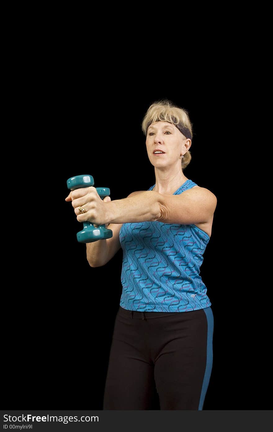 Middle-aged woman exercising with weights to music doing arobics and enjoying it. Middle-aged woman exercising with weights to music doing arobics and enjoying it