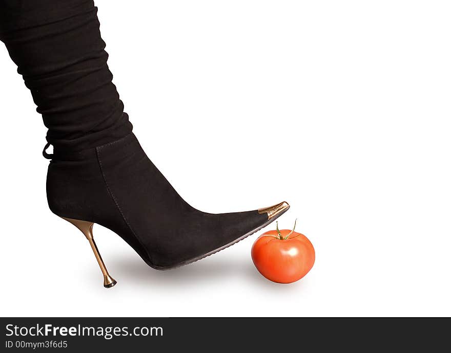 Black boots and tomato on a white background