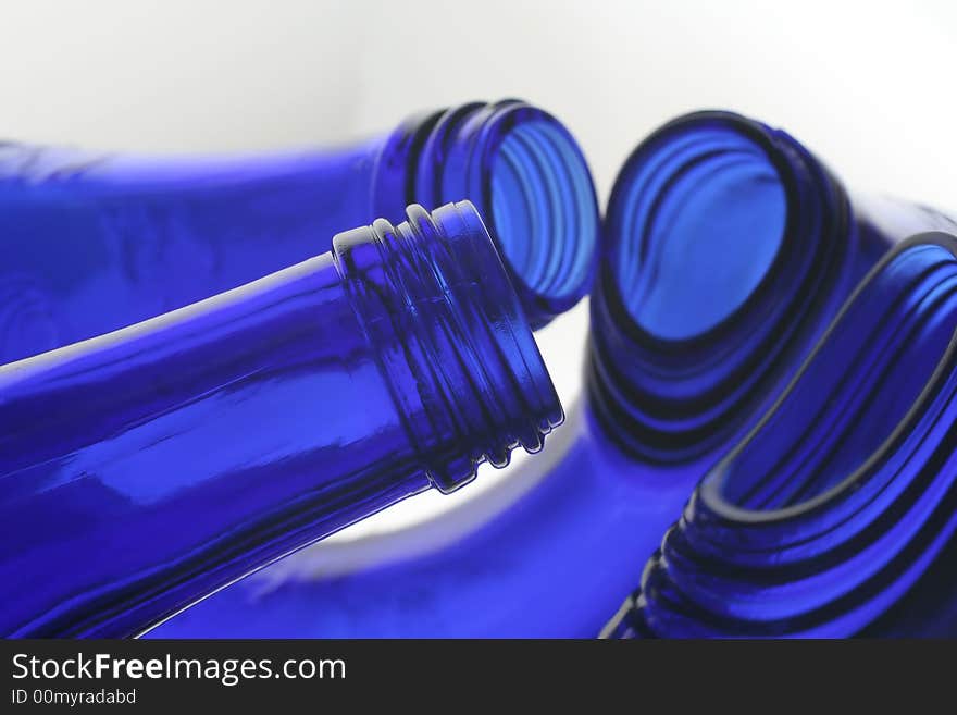 Mouth and neck of cobalt blue bottles with reflections