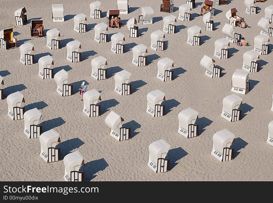 A hot summer day and a lot of beach chairs collected together at the Baltic Sea on Rügen nearby the Sellin Sea Bridge