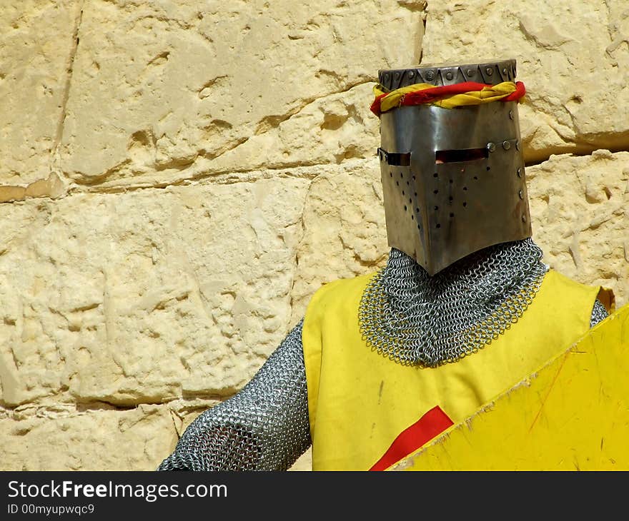 A man in historic costume with metal armour and shield. A man in historic costume with metal armour and shield