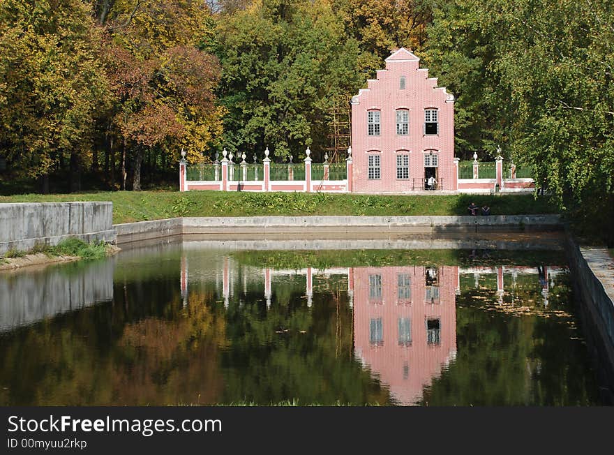 Pink small house reflected in water