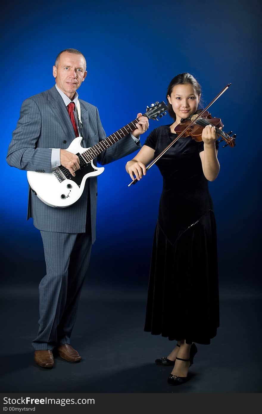 A photo of a duet - guitarist and violinist