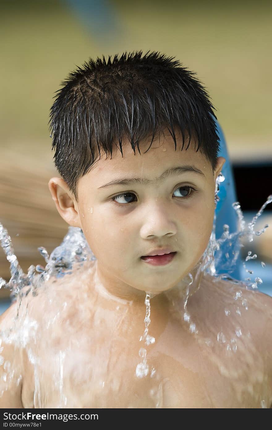 Kid playing with waterfountain