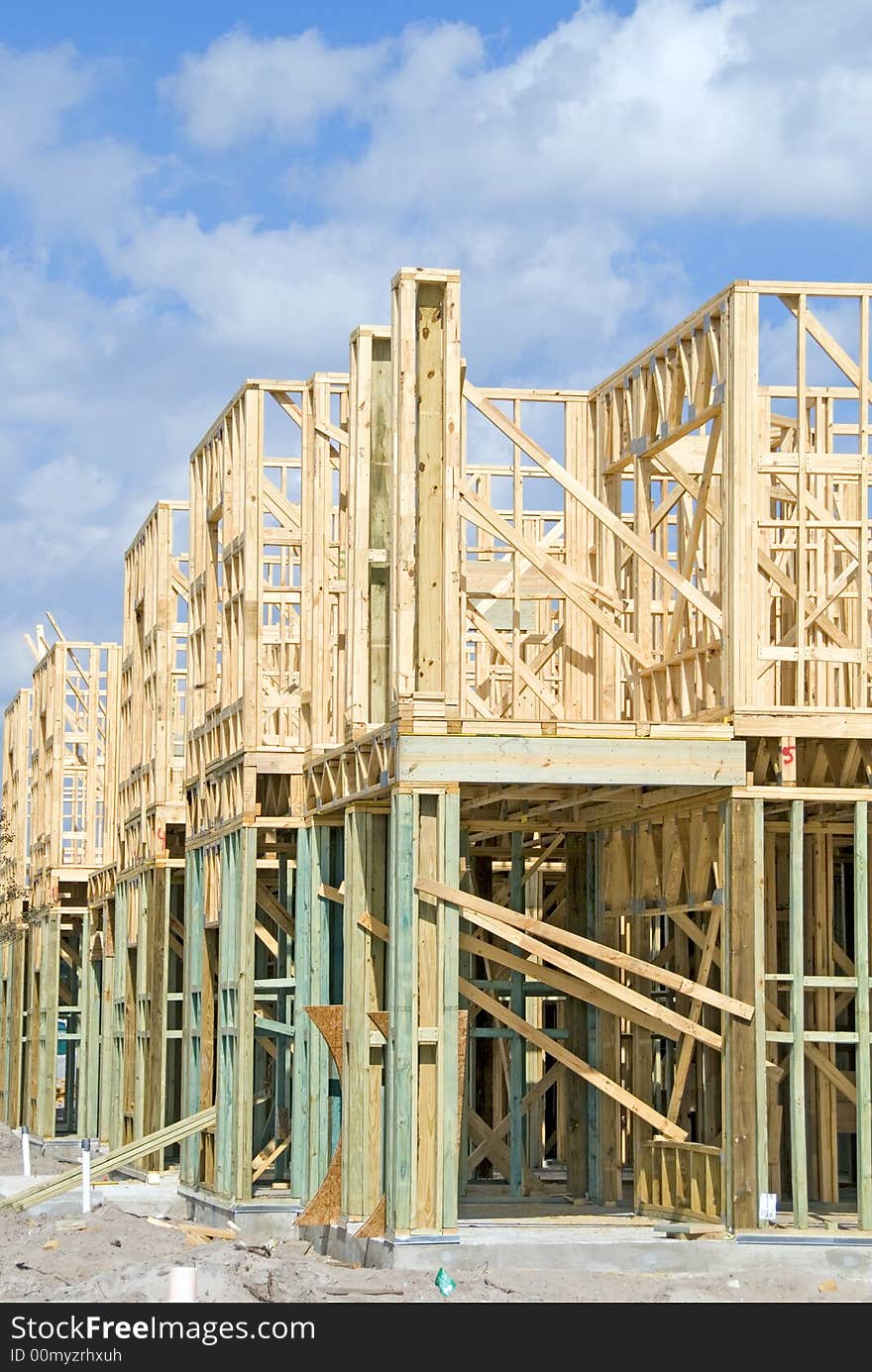 Two story frame condos under construction and a clear day. Two story frame condos under construction and a clear day