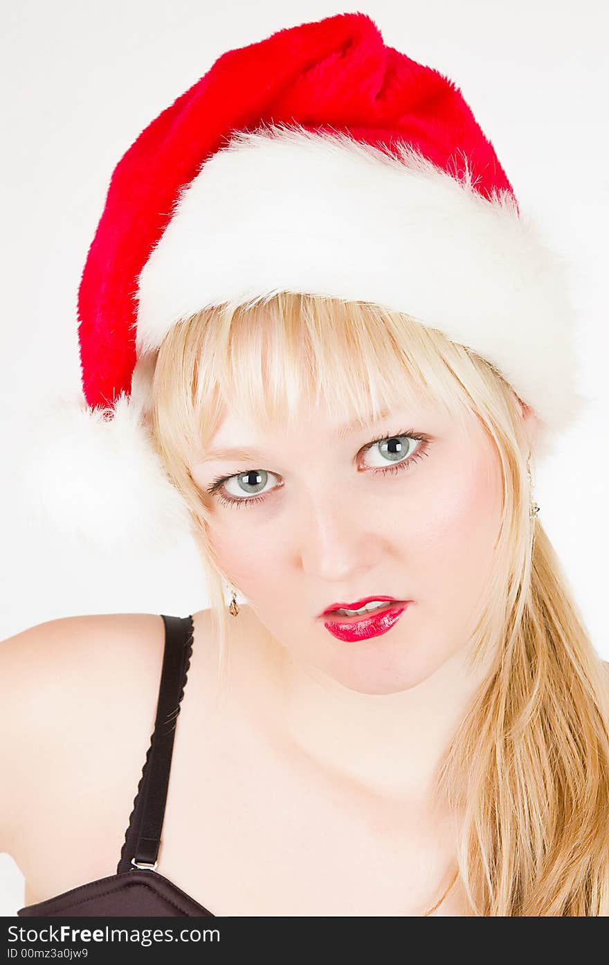 Attractive girl in a christmas hat studio shot. Attractive girl in a christmas hat studio shot