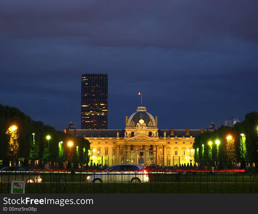 The Champs de Mars with Montparnasse Tower and the Ecole Militaire by night (the building opposed to the Eiffel Tower). Paris, France.