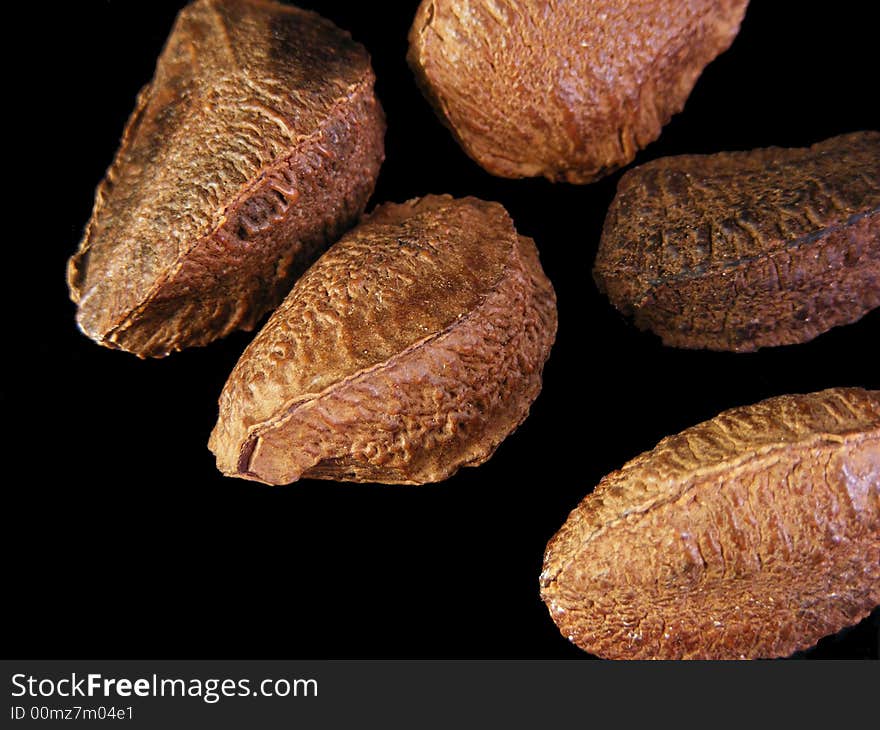 Unshelled brazil nuts against a black background. Unshelled brazil nuts against a black background.