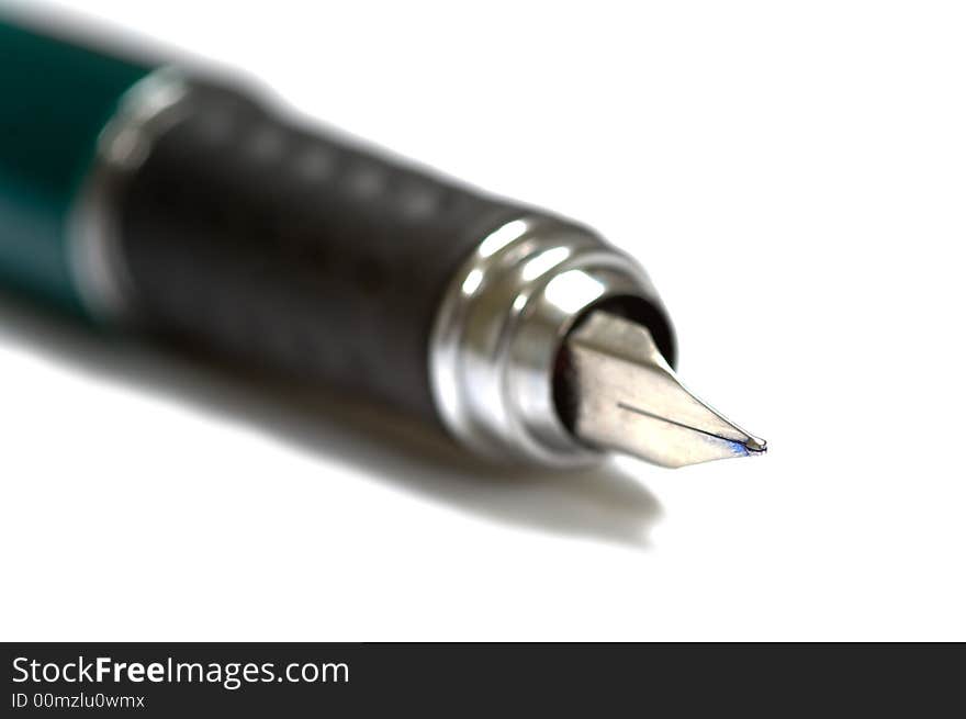Fountain pen on white with very shallow depth of field on white background, focus is on the tip of the pen