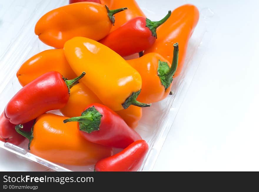 Fresh sweet peppers on white background, with copy space