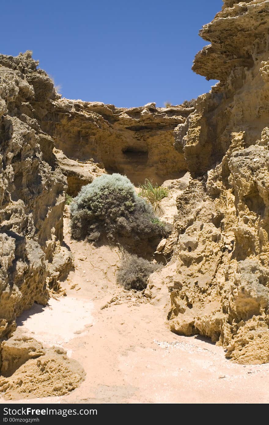 The face of the rocky cliff agains blue sky. The face of the rocky cliff agains blue sky