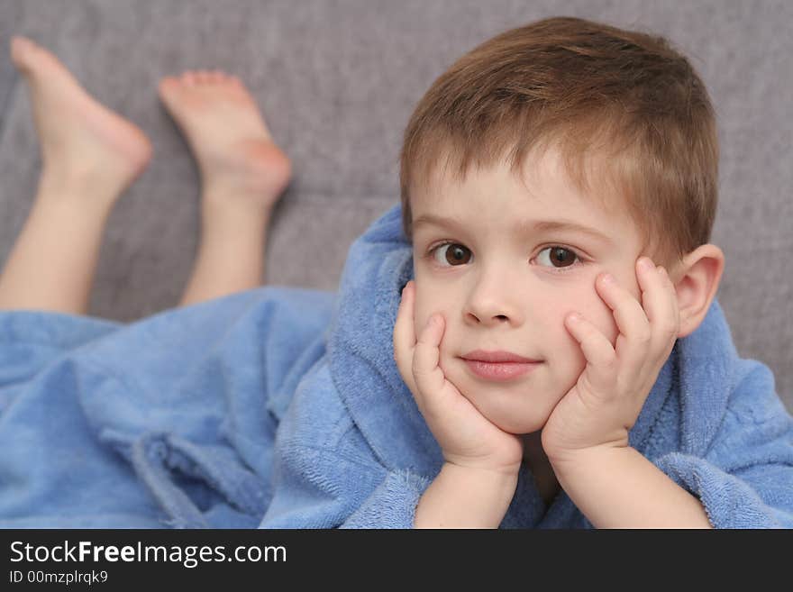 The sight of the boy which lays on a sofa