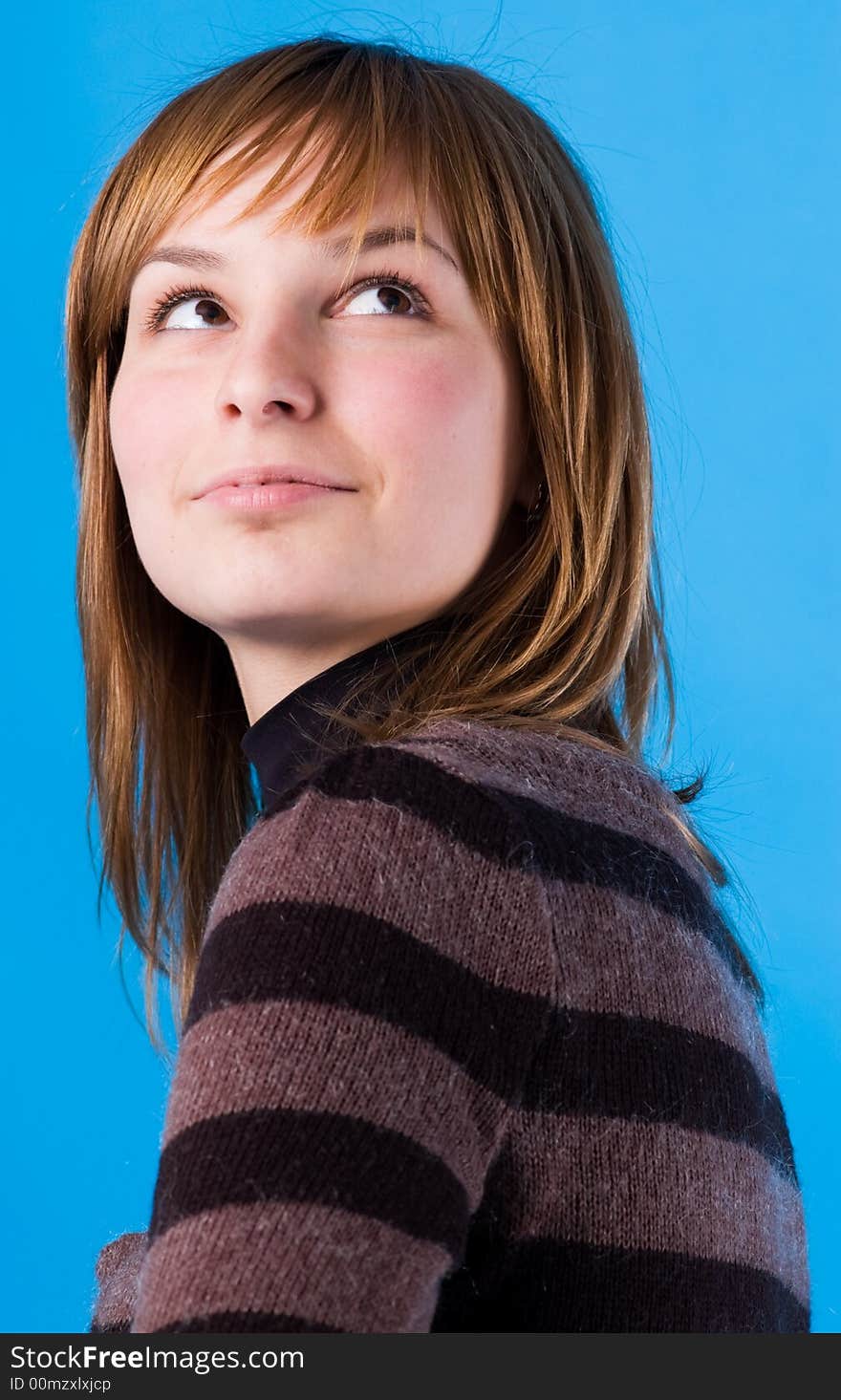 The girl looks, isolated on a dark blue background. The girl looks, isolated on a dark blue background.