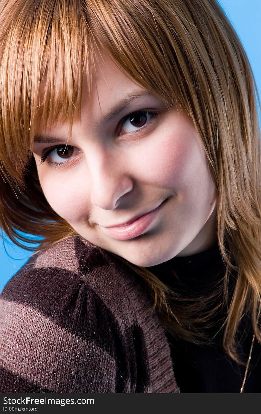 The girl playfully looks, isolated on a dark blue background. The girl playfully looks, isolated on a dark blue background.