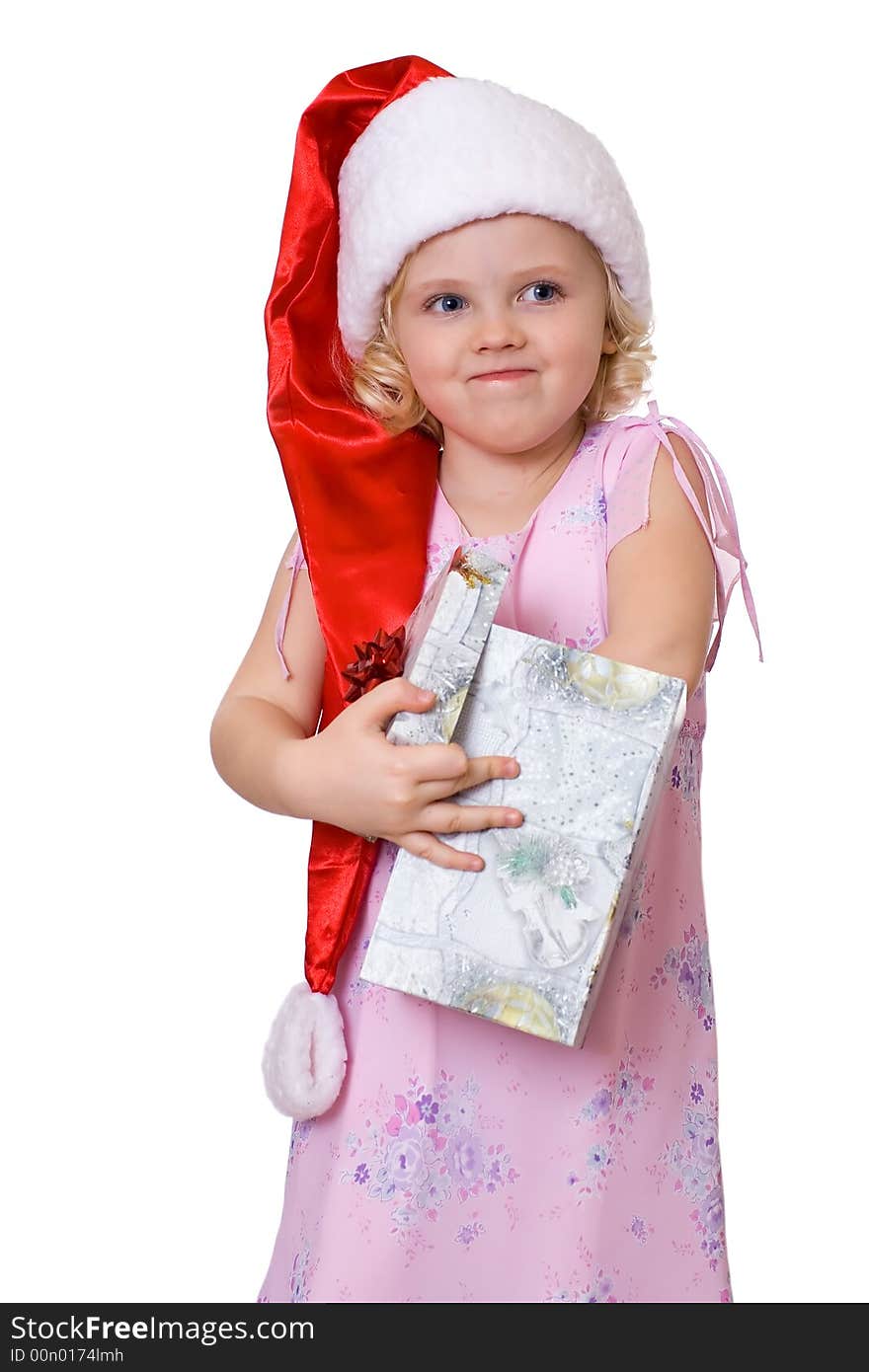 Cute fair-haired girl in Santa's hat getting out present  from the box. Cute fair-haired girl in Santa's hat getting out present  from the box