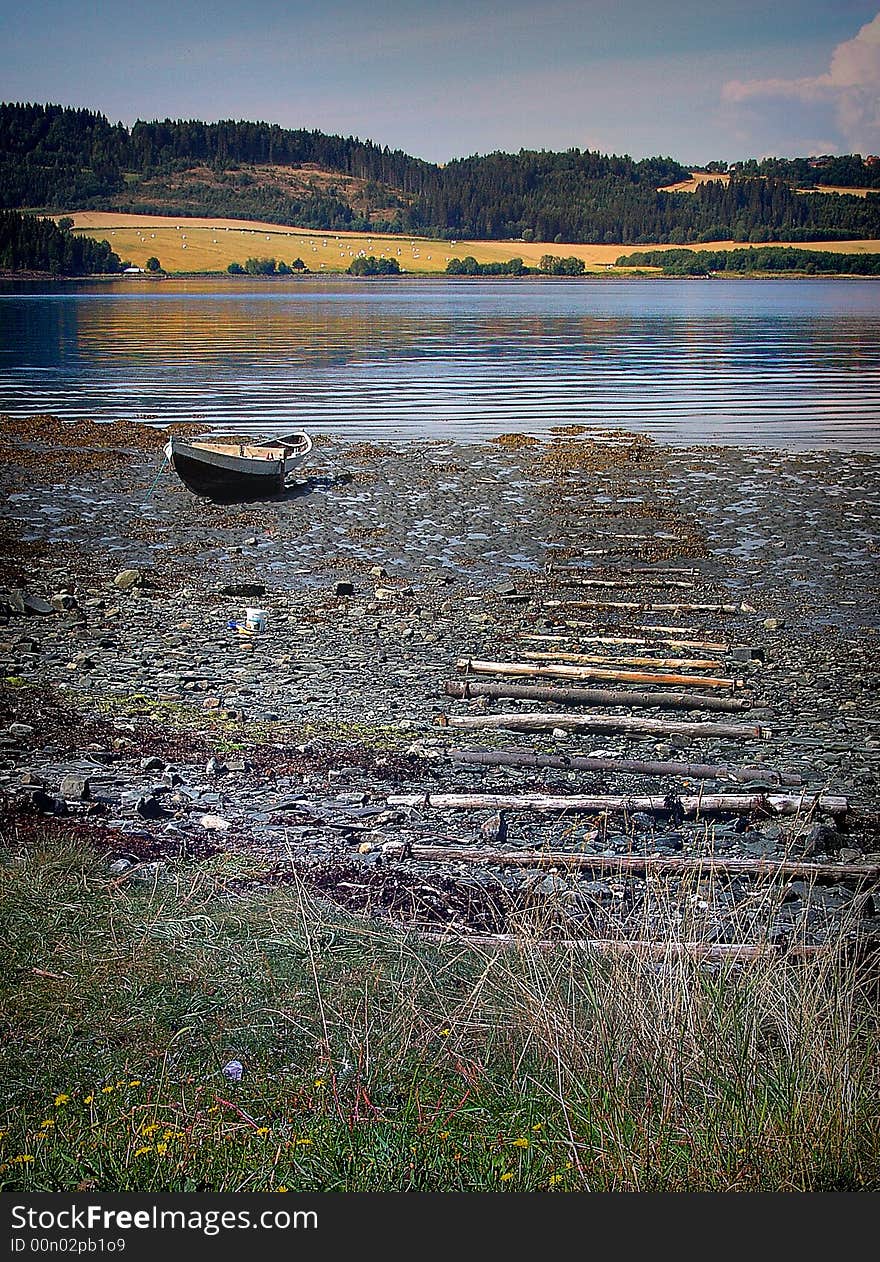 Lonely boat on North Sea beach in Norway.