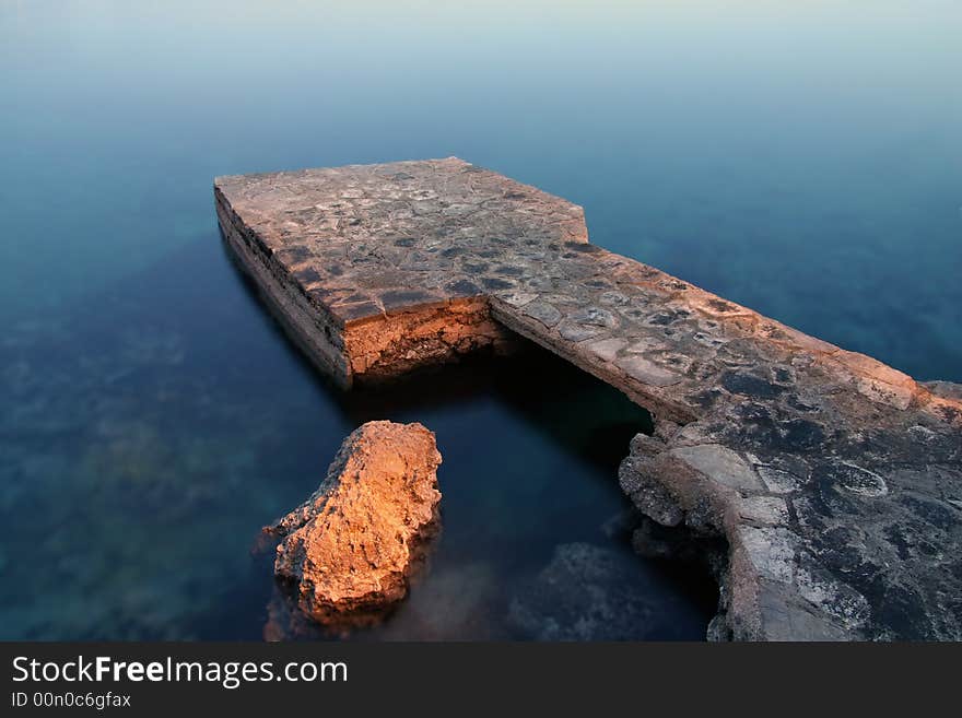 Breakwater painted with light at night - long exposure