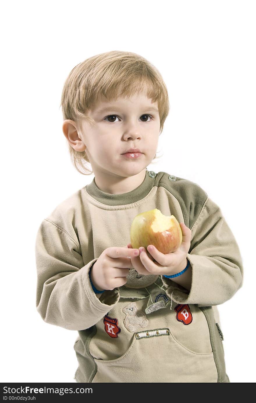 Young girl posing and holding apple in her hands