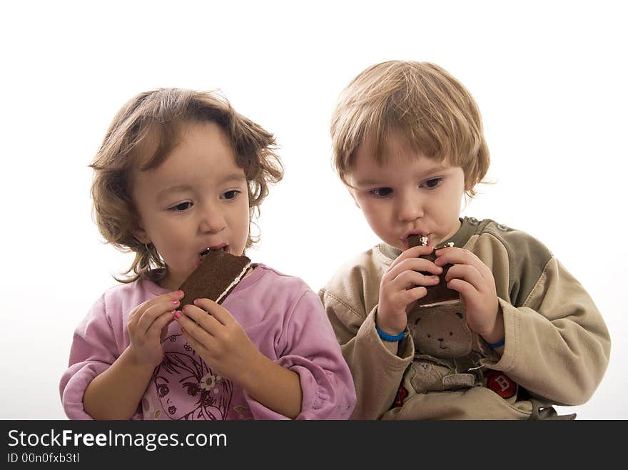 Twin sisters eating chocolate bars