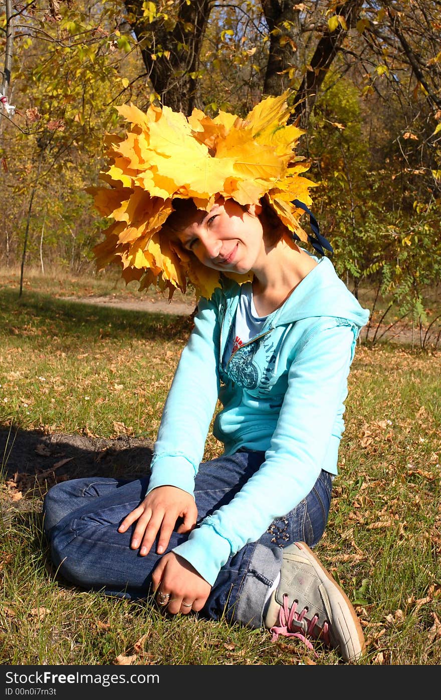 Portrait of the girl in a wreath from maple leaves