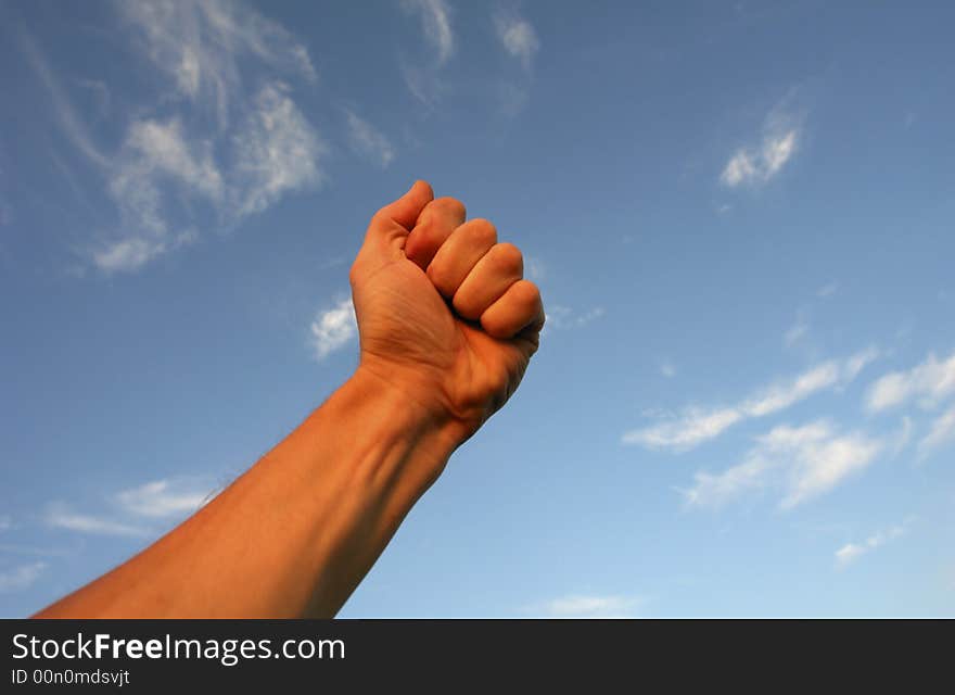 Hand on a background of clouds