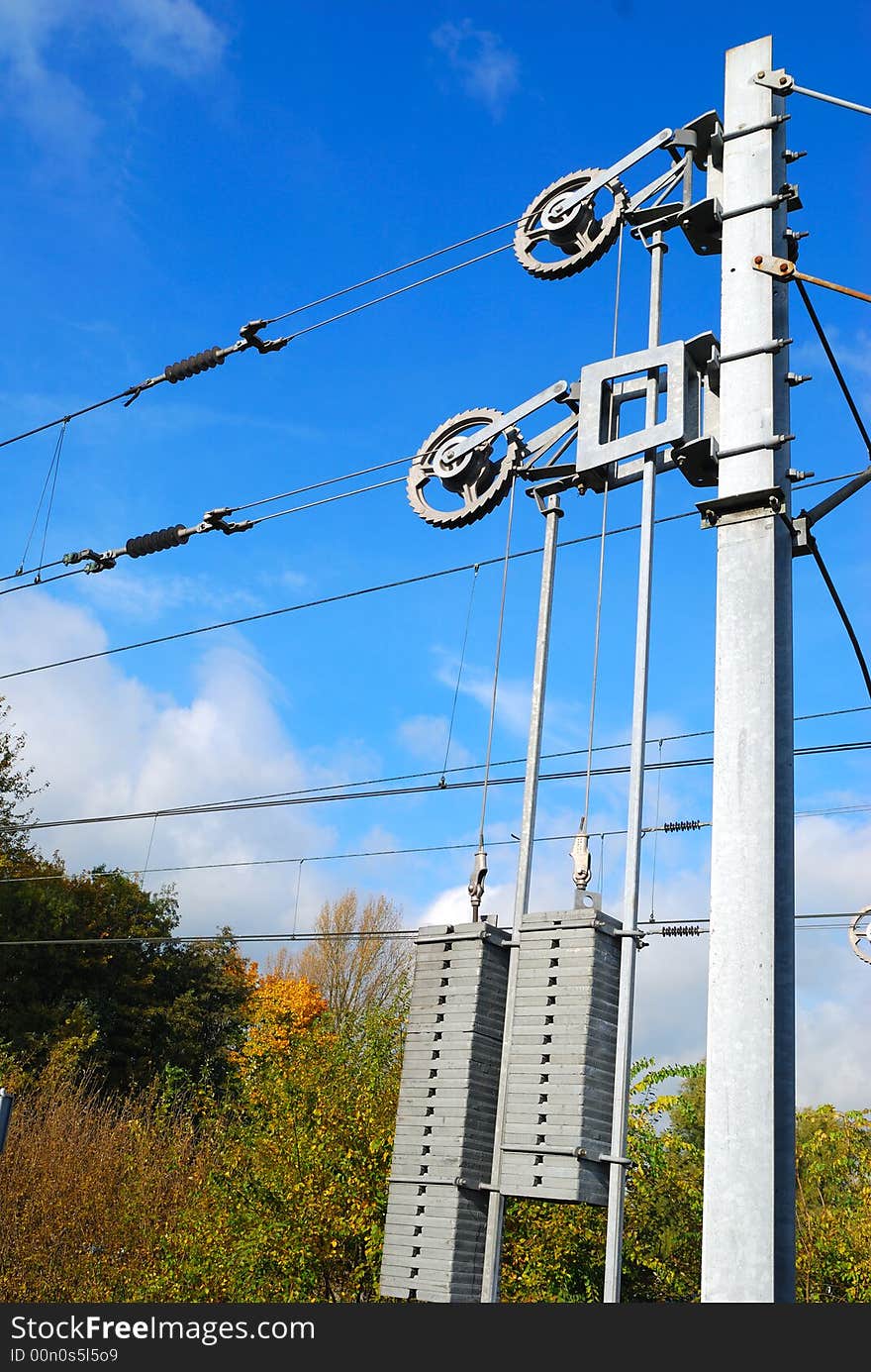 Track electricity line tensioner and Weights with blue sky and white clouds