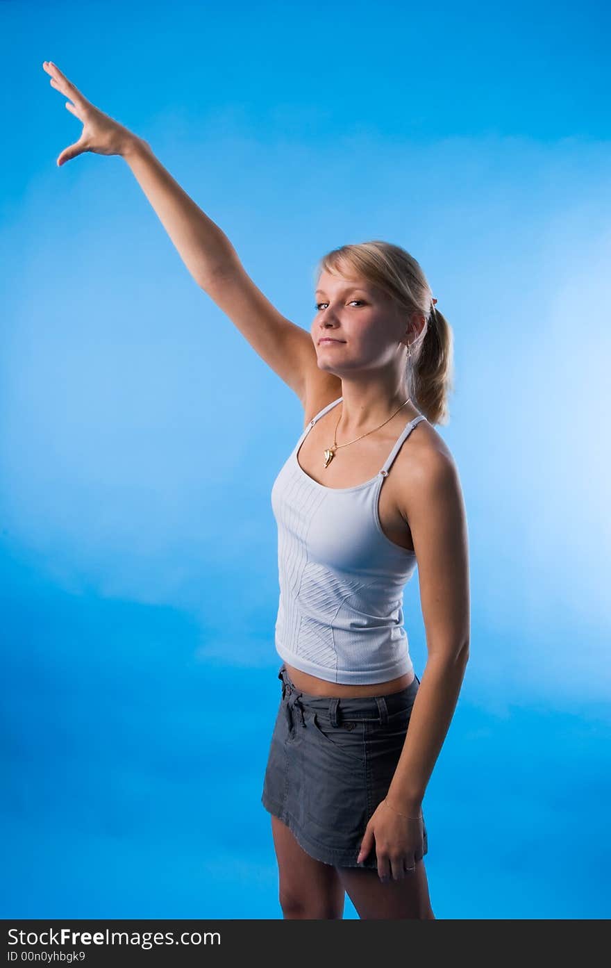 The girl in a white vest tries to reach the sky