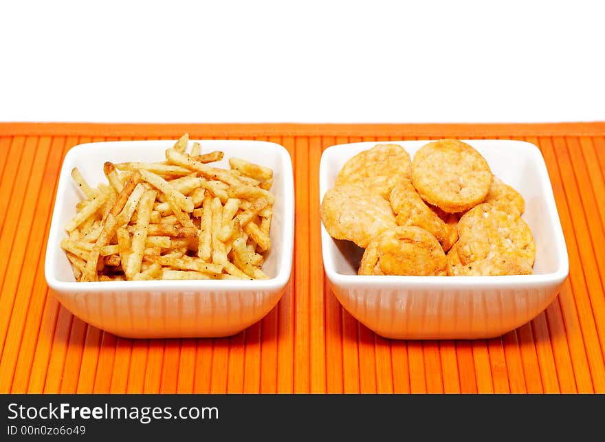 Two bowls with a variety of snacks on white background. Two bowls with a variety of snacks on white background