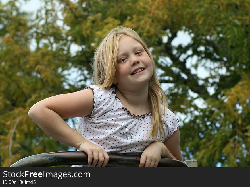 Happy, smiling young girl at the park enjoying the sunshine. Happy, smiling young girl at the park enjoying the sunshine