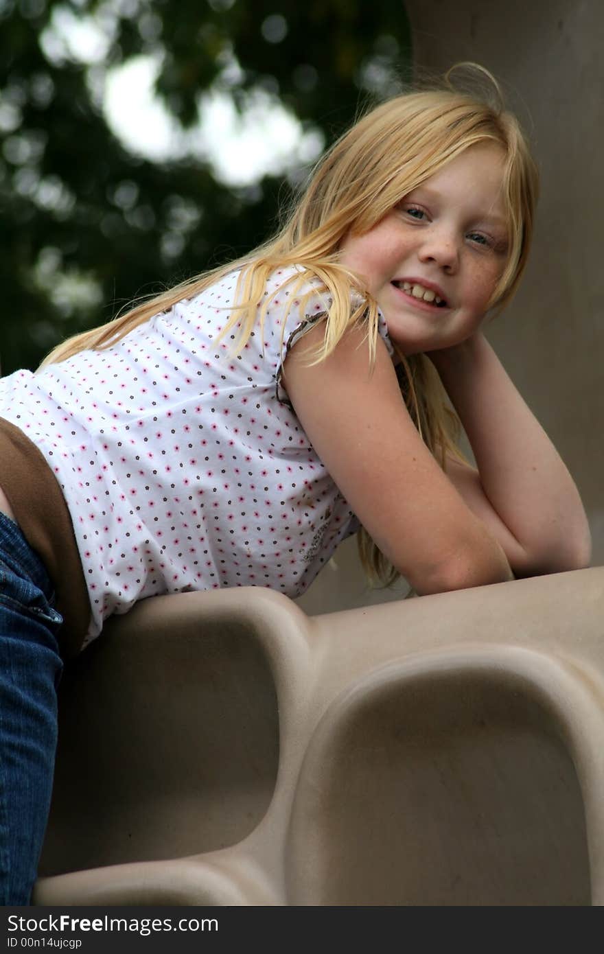 Happy, smiling young girl at the park enjoying the sunshine. Happy, smiling young girl at the park enjoying the sunshine