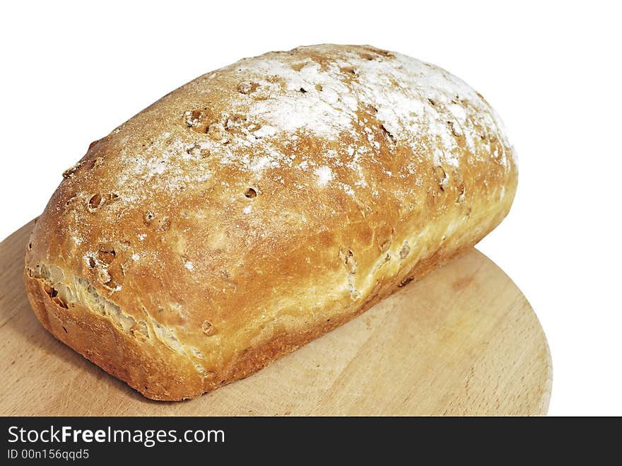 Fresh baked bread on the wooden plate