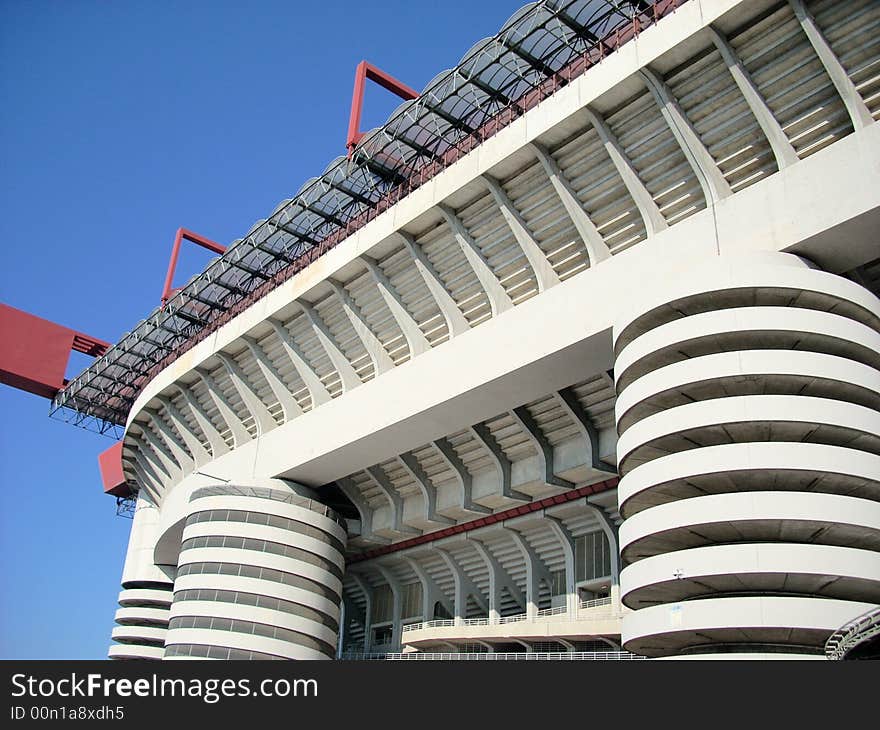 A part of the San Siro stadium in Milan under a blue sky. A part of the San Siro stadium in Milan under a blue sky