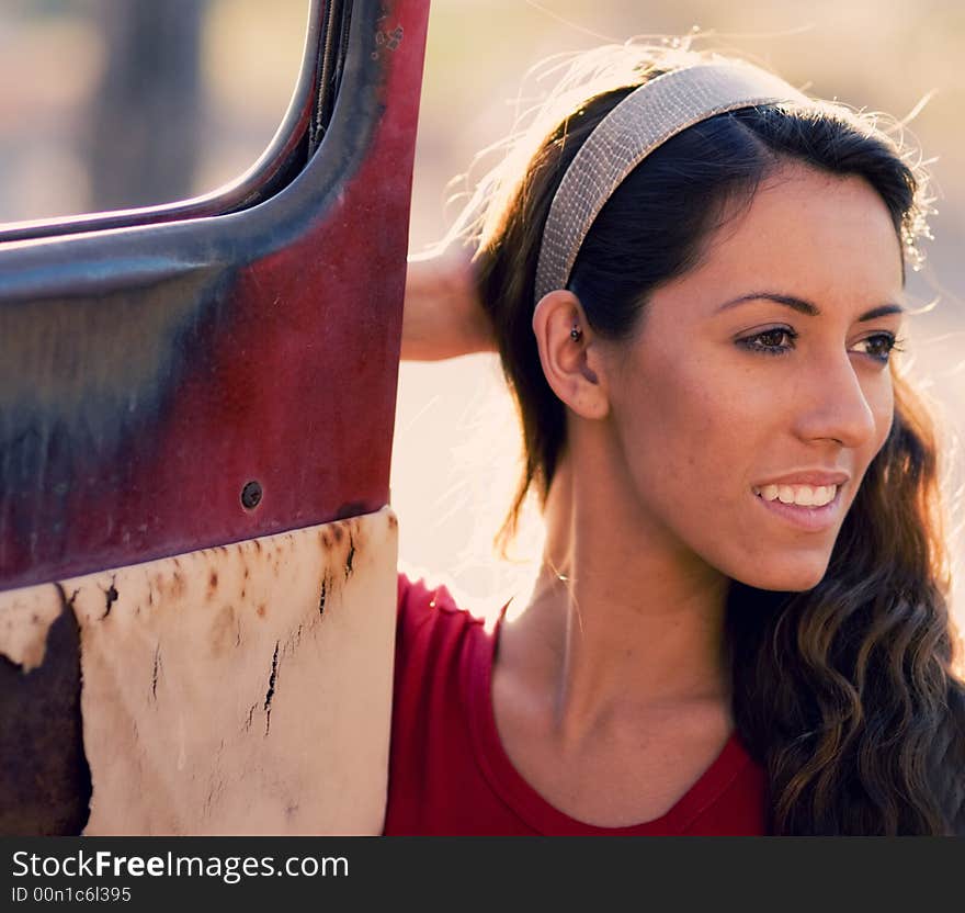 Woman beside old rusty truck door