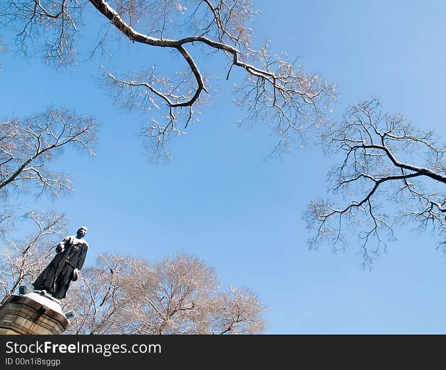 Russian revolutionaries Sergey Lazo statue in russian city Vladivostok against the snow trees and blue sky