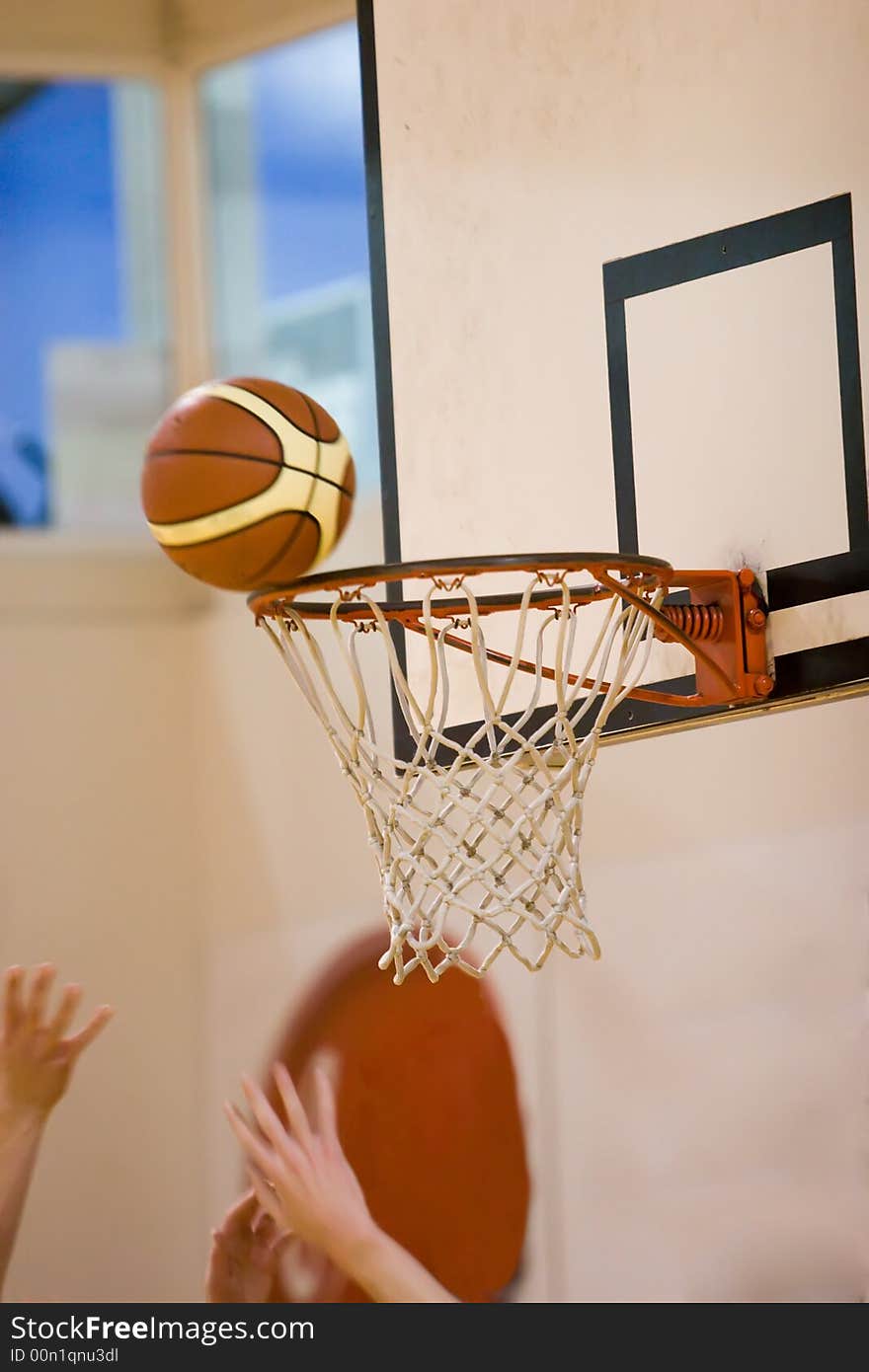 Basketball balancing on the edge of the hoop