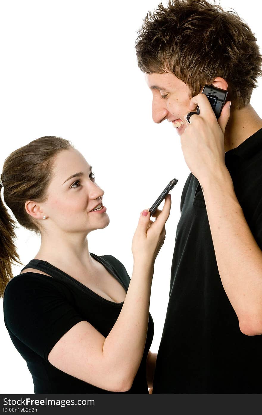 A young couple on the phone together. A young couple on the phone together