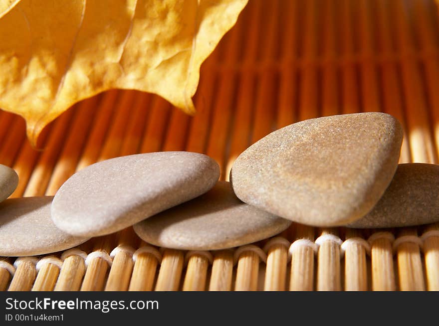 Five flat stones over autumn leaves. Five flat stones over autumn leaves