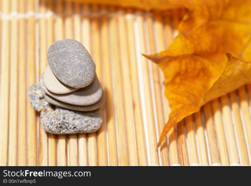 Five flat stones over autumn leaves. Five flat stones over autumn leaves