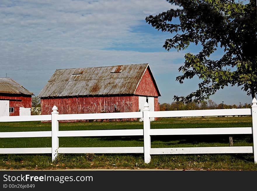 Senic barn with fence and blue skies in early morning. Senic barn with fence and blue skies in early morning.